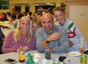 Woman, man and two children at Annual Italian Potluck Dinner