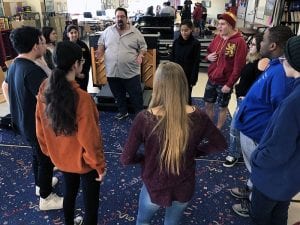 Actor Adam Sietz leaders students in a round of drama exercise