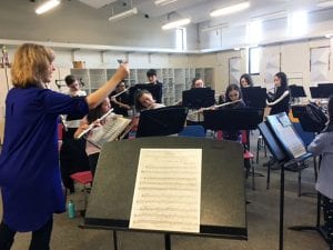 Master flutist conducting class of students