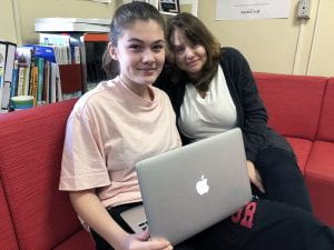 Student with adult mentor and laptop