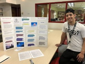 Male student with research poster