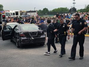 Student walking away from mock accident with police officers