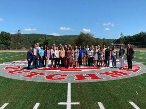 Photo of group of new teachers on turf football field