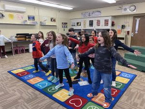 Second graders rehearse their spring play