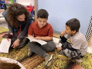 First grader reading to kindergartener