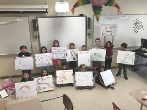 K-2 students show off original game boards they created at Summer STEAM Camp in July 2017.