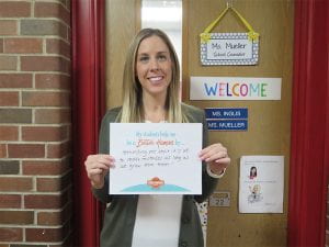 School Counselor holding sign for National School Counseling Week