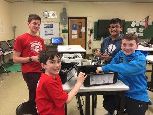 Members of the robotics team smiling in the Challenge Lab