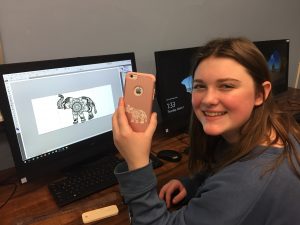 SOMS student Catherine M. with cellphone case design she customized and engraved with new CNC laser cutter