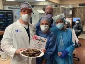 Healthcare workers with thank you card and brownies